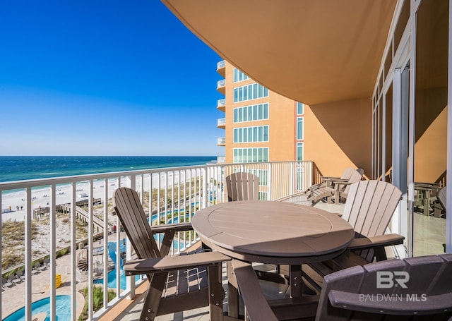 balcony with a beach view and a water view