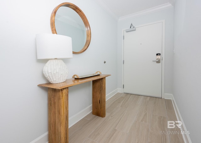 entrance foyer with baseboards, ornamental molding, and light wood finished floors