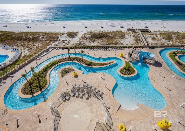 aerial view with a water view and a beach view