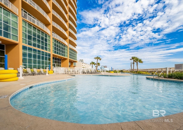 community pool with a patio area