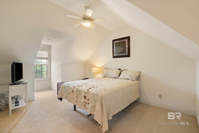 bedroom with carpet flooring, vaulted ceiling, and baseboards