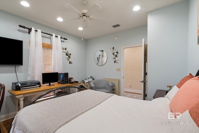 bedroom featuring baseboards, visible vents, wood finished floors, and recessed lighting