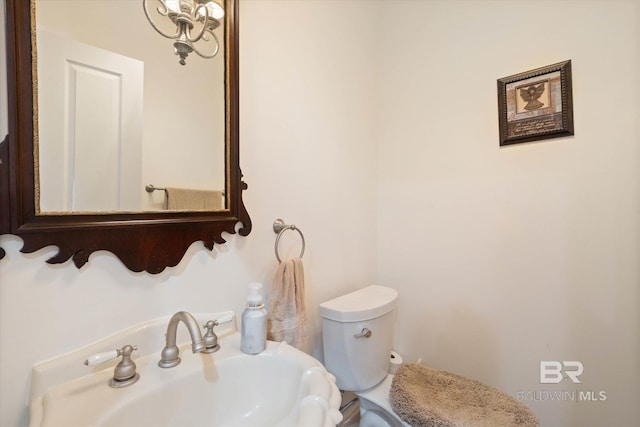 half bath with toilet and a sink