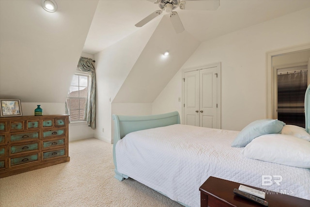 bedroom featuring carpet floors, a closet, baseboards, a ceiling fan, and lofted ceiling