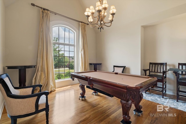 recreation room with a chandelier, vaulted ceiling, light wood-style flooring, and pool table