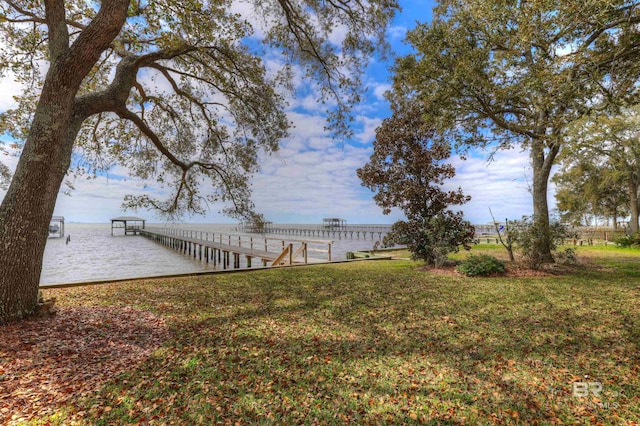 view of dock with a lawn