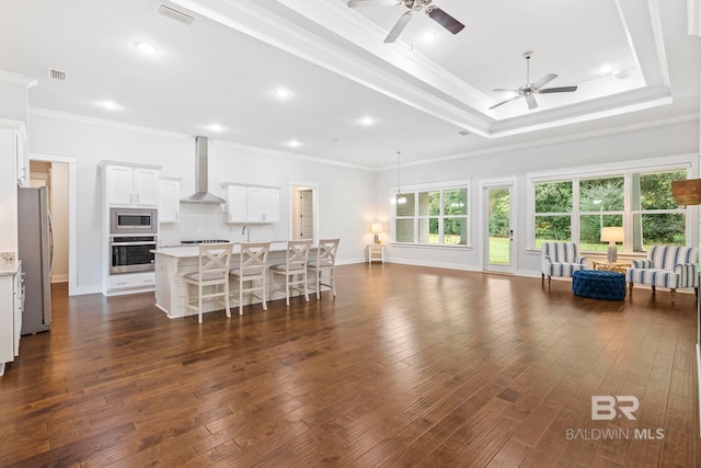 360 Nandina Loop, Fairhope, AL 36532 - living area featuring a ceiling fan, ornamental molding, dark wood-type flooring, baseboards, and a raised ceiling