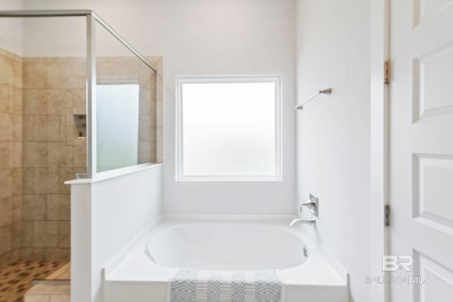 bathroom with separate shower and tub