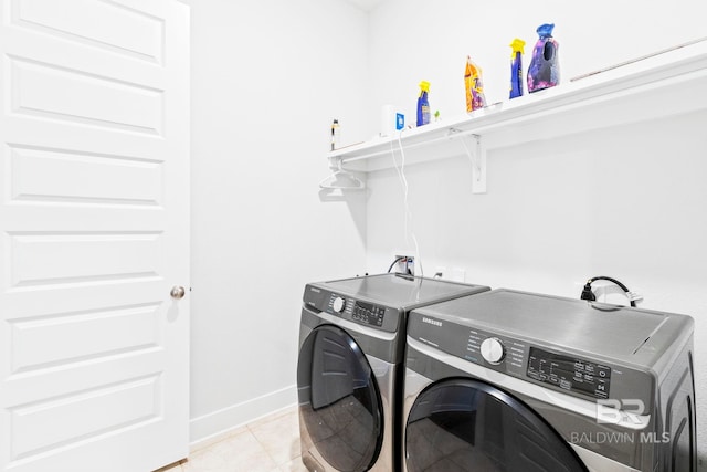 laundry room with light tile patterned flooring and separate washer and dryer