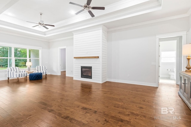 360 Nandina Loop, Fairhope, AL 36532 - unfurnished living room with a raised ceiling, ornamental molding, a ceiling fan, wood finished floors, and baseboards