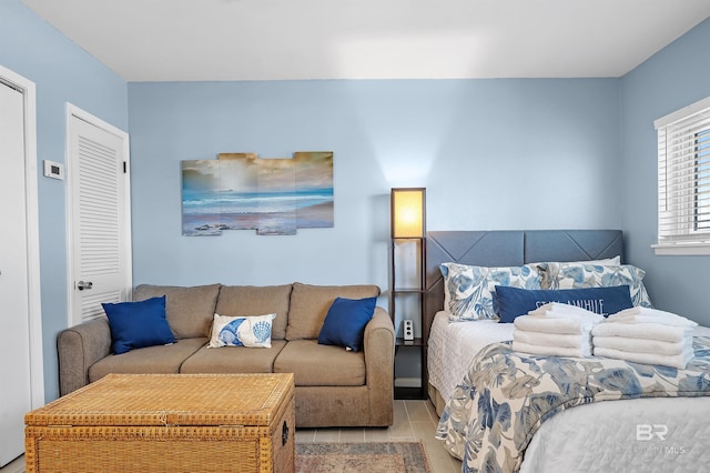 bedroom with a closet and light tile patterned floors