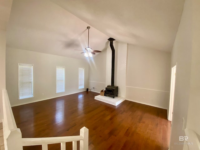 unfurnished living room featuring high vaulted ceiling, a wood stove, ceiling fan, and hardwood / wood-style flooring