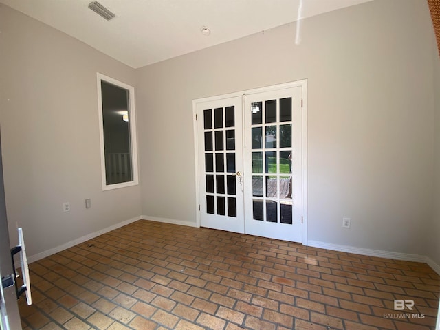 unfurnished room featuring french doors