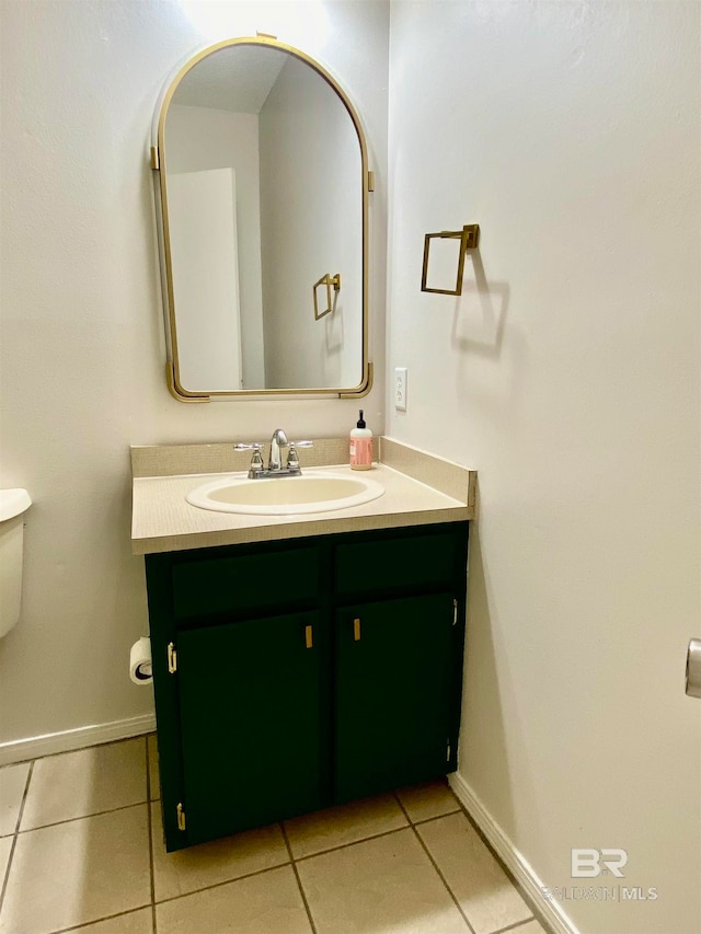 bathroom featuring vanity, tile floors, and toilet