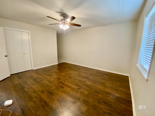 unfurnished bedroom with hardwood / wood-style flooring, ceiling fan, and a textured ceiling