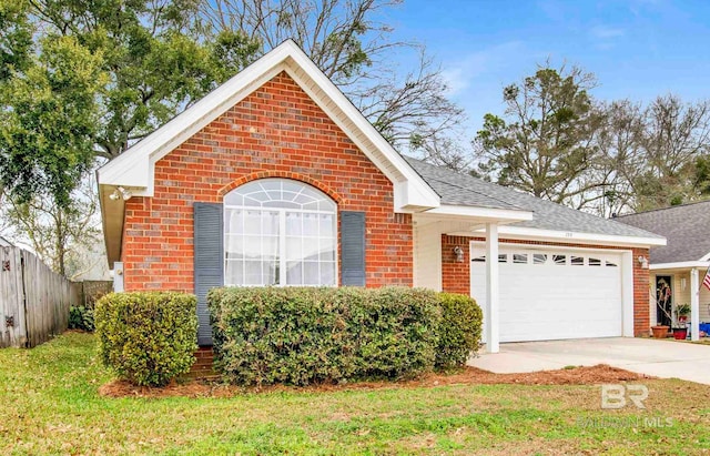 view of front of property featuring a garage and a front lawn