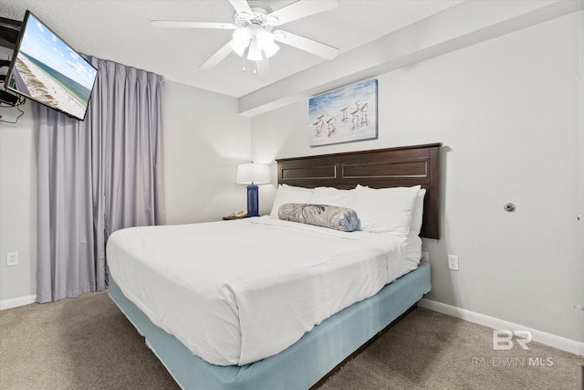 carpeted bedroom with ceiling fan and baseboards