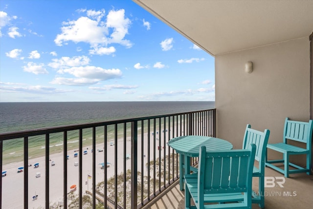 balcony with a view of the beach and a water view