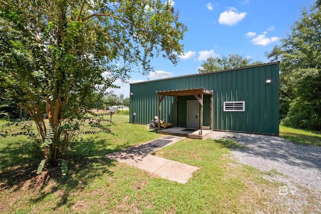 view of outbuilding featuring a lawn