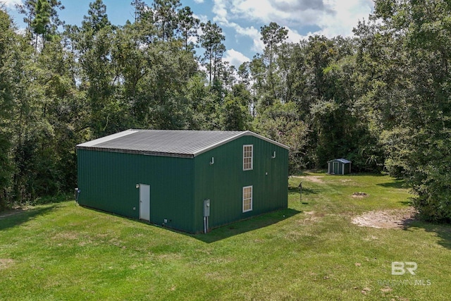 view of outbuilding with a yard