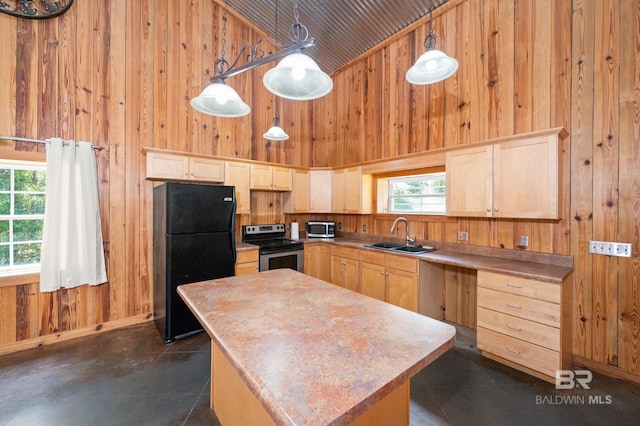 kitchen with high vaulted ceiling, light brown cabinetry, wooden walls, sink, and stainless steel appliances