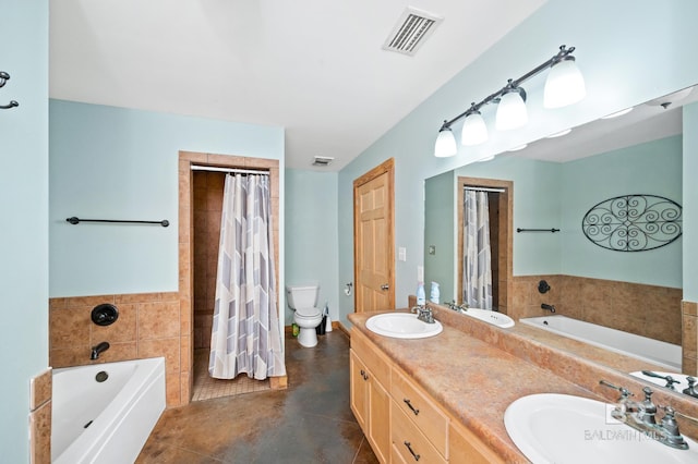 bathroom featuring vanity, tile patterned floors, toilet, and a bathing tub