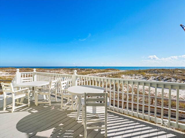 deck with a water view and a beach view