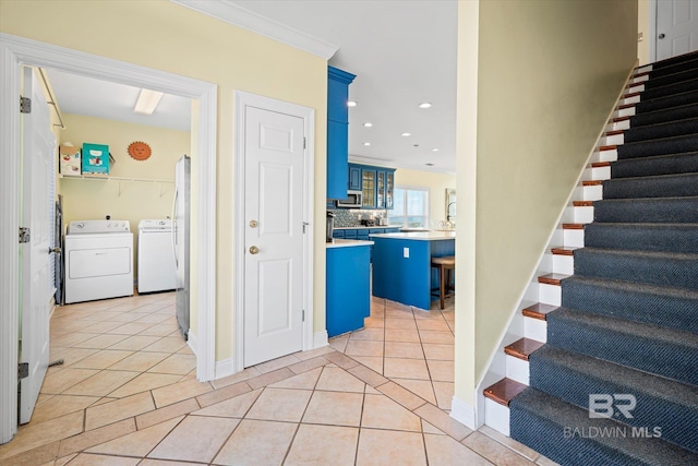 stairway featuring ornamental molding, washer and clothes dryer, tile patterned flooring, and recessed lighting