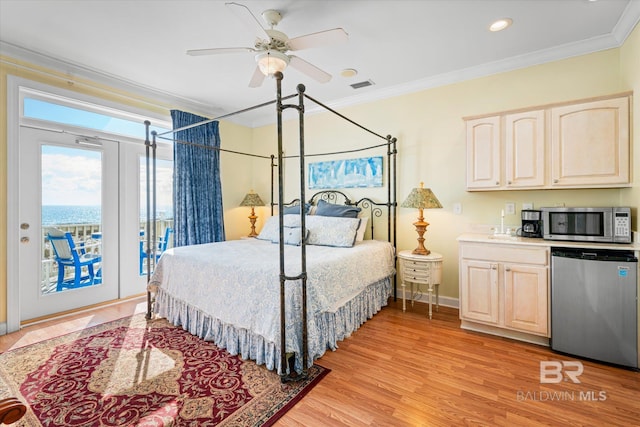 bedroom with access to exterior, visible vents, light wood-style flooring, ornamental molding, and baseboards