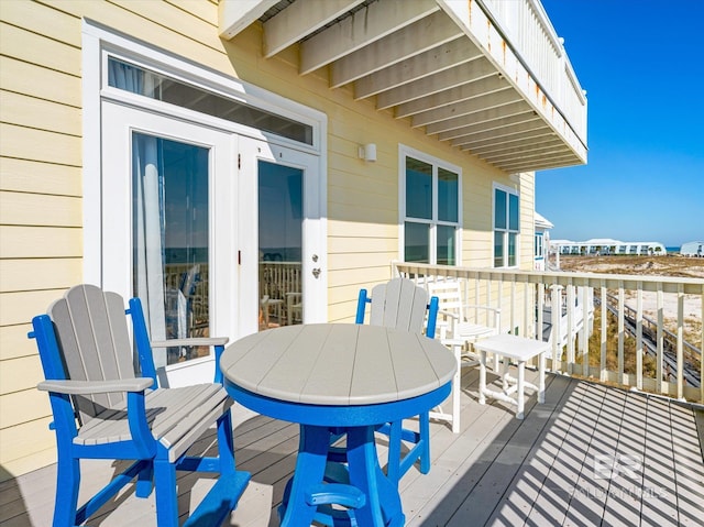 wooden terrace with outdoor dining space