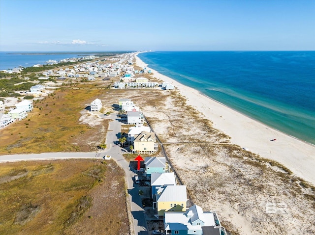 drone / aerial view featuring a water view and a beach view