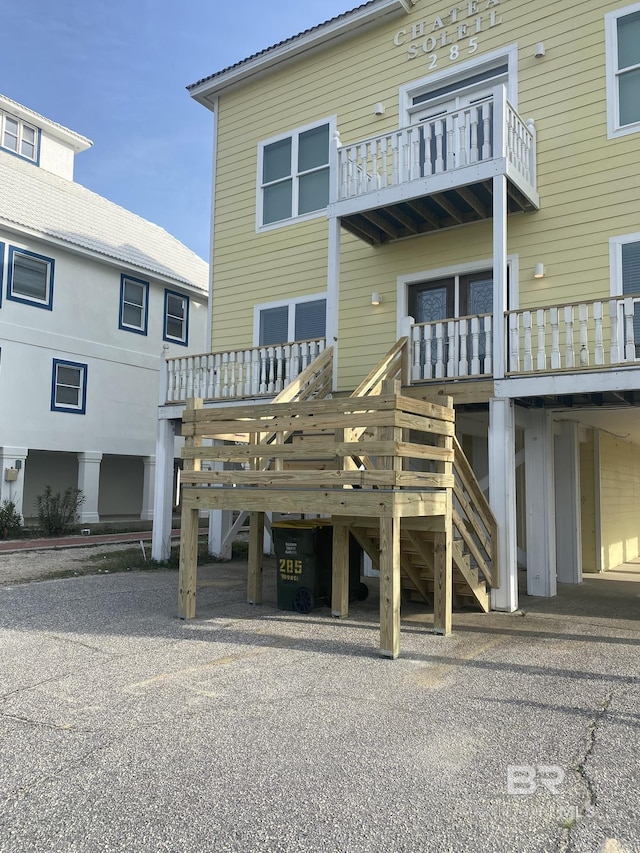 back of property with stairway and a wooden deck