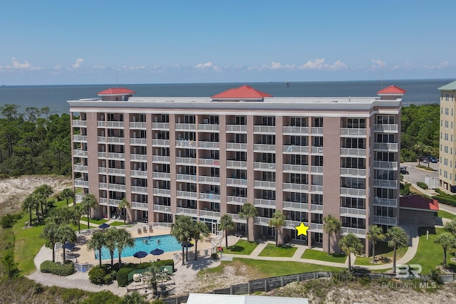 view of property featuring a community pool and a water view