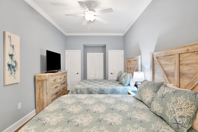 bedroom with ceiling fan, ornamental molding, and wood-type flooring