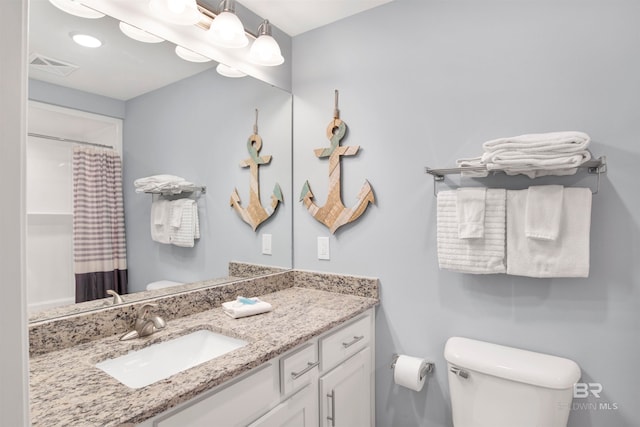 bathroom with vanity, toilet, and a shower with shower curtain