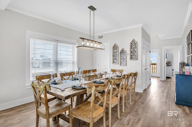 dining space featuring baseboards, a healthy amount of sunlight, and light wood finished floors