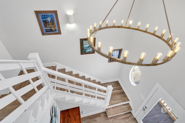 stairway featuring wood finished floors and baseboards