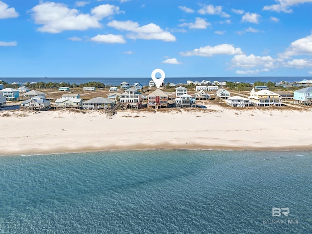 bird's eye view with a water view and a beach view