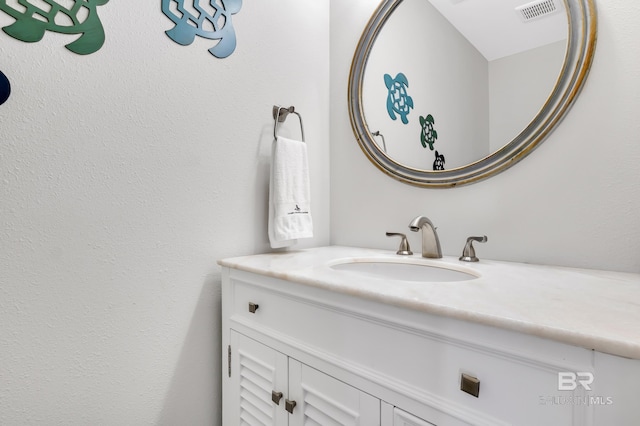 bathroom with visible vents and vanity