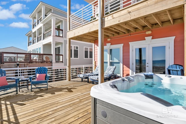 wooden deck featuring french doors and a hot tub