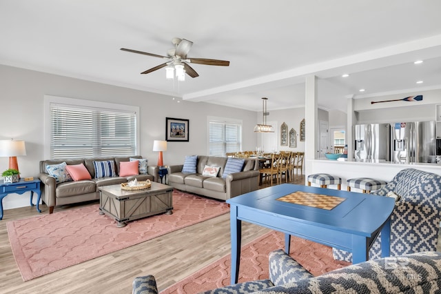 living room featuring a ceiling fan, crown molding, recessed lighting, and wood finished floors