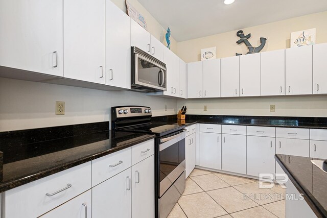 4615 Nancy Ln Unit 8, Orange Beach, AL 36561 - kitchen featuring stainless steel appliances, white cabinetry, dark stone countertops, and light tile patterned floors