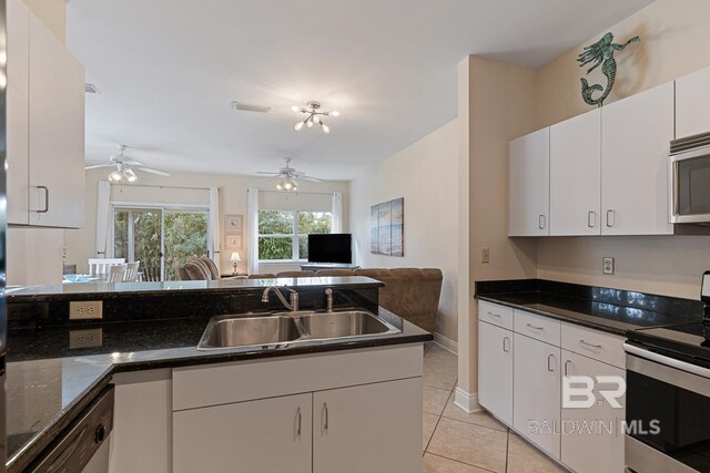 4615 Nancy Ln Unit 8, Orange Beach, AL 36561 - kitchen featuring light tile patterned flooring, stainless steel appliances, sink, and white cabinets