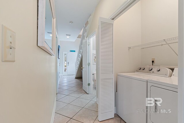 4615 Nancy Ln Unit 8, Orange Beach, AL 36561 - laundry area with light tile patterned floors and washing machine and clothes dryer