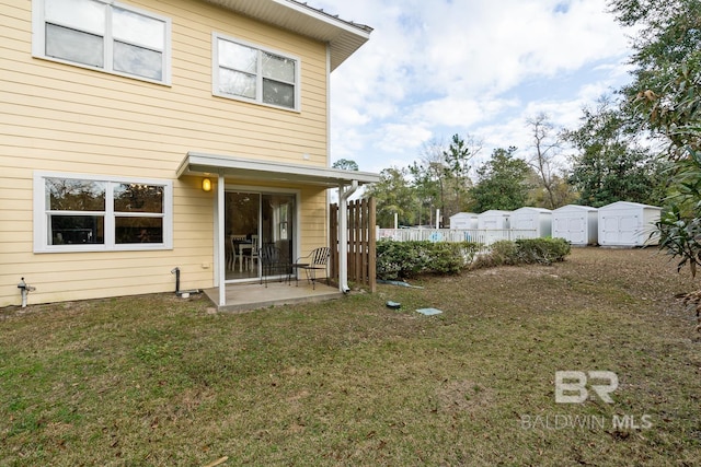 4615 Nancy Ln Unit 8, Orange Beach, AL 36561 - rear view of house with a patio and a lawn