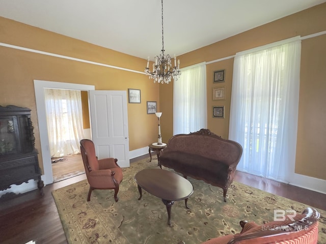 living room with an inviting chandelier and dark hardwood / wood-style flooring