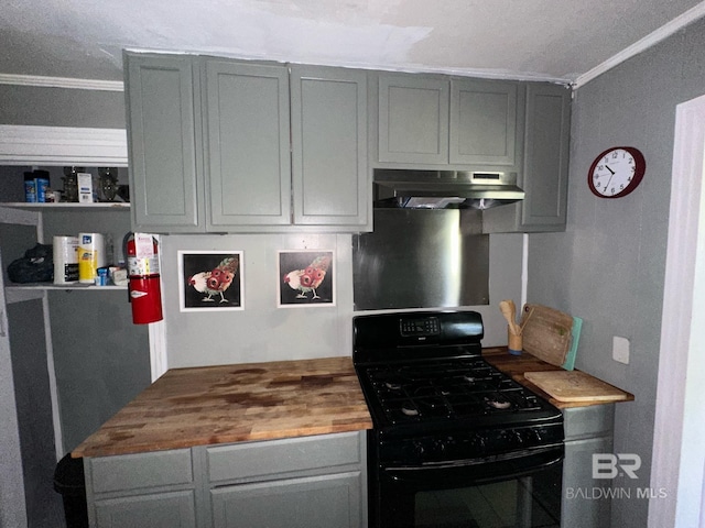 kitchen featuring black gas range oven, wall chimney range hood, crown molding, butcher block countertops, and gray cabinets