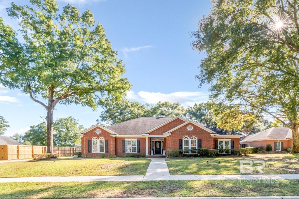 ranch-style house featuring a front lawn