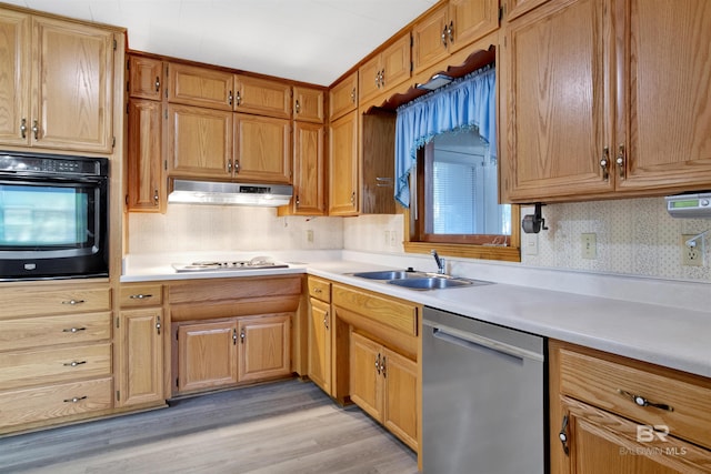 kitchen featuring white gas stovetop, black oven, sink, backsplash, and stainless steel dishwasher