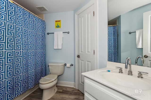 bathroom with hardwood / wood-style floors, vanity, and toilet